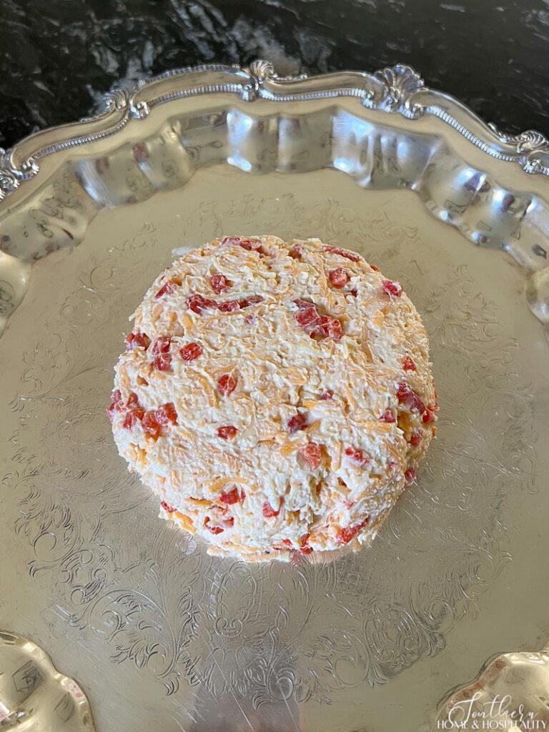 Cheese ball turned out of bowl onto serving platter