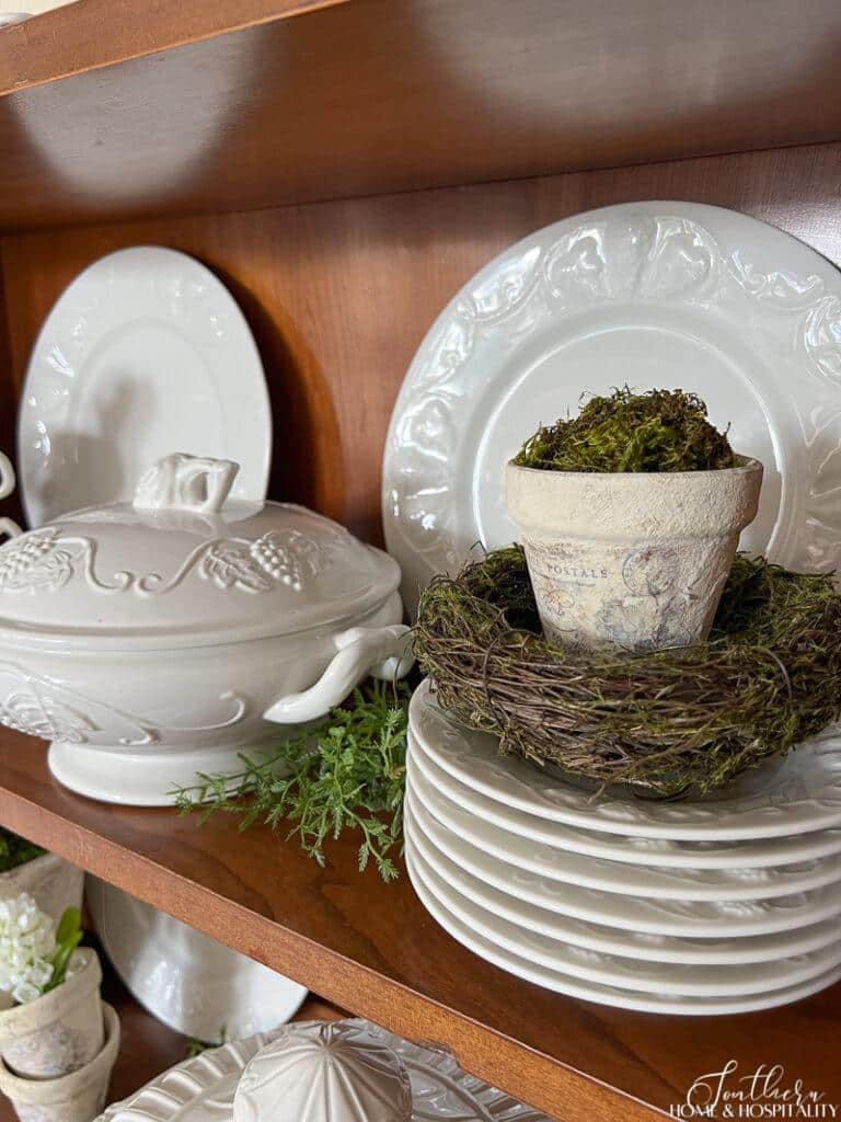 Vintage garden pot, spring nest, and white ironstone