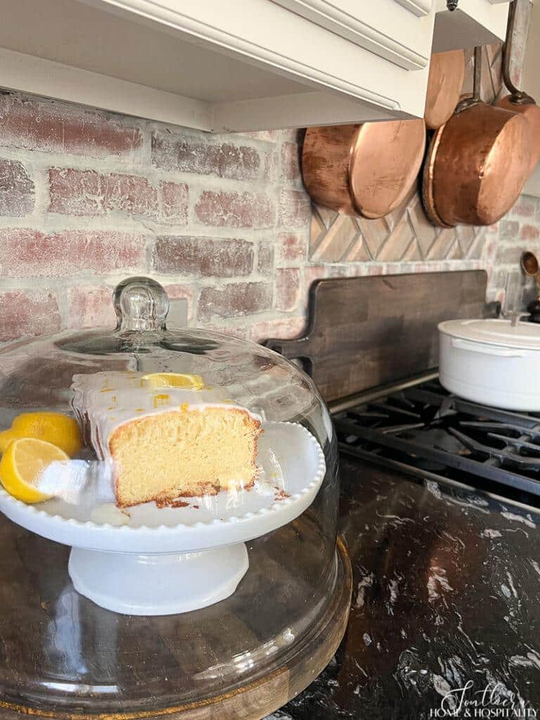 Lemon cake in a dessert cloche on kitchen counter