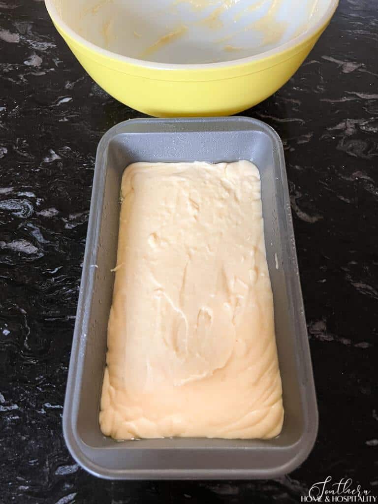 Raw lemon loaf batter in pan ready for baking