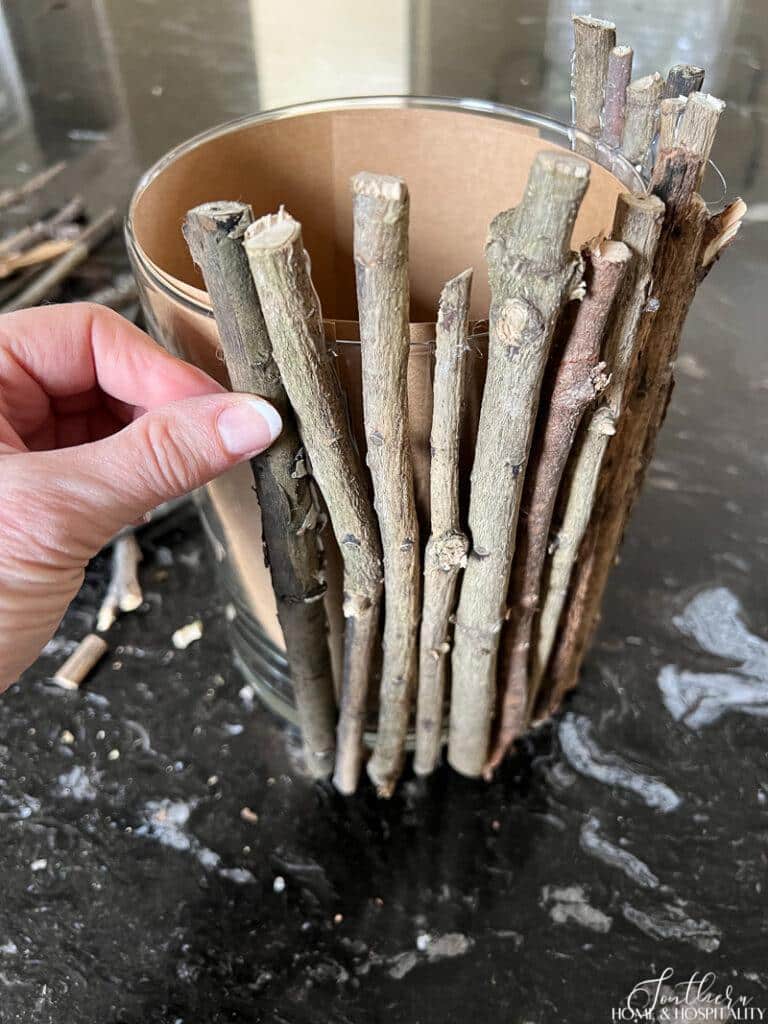 Attaching twigs to vase with hot glue