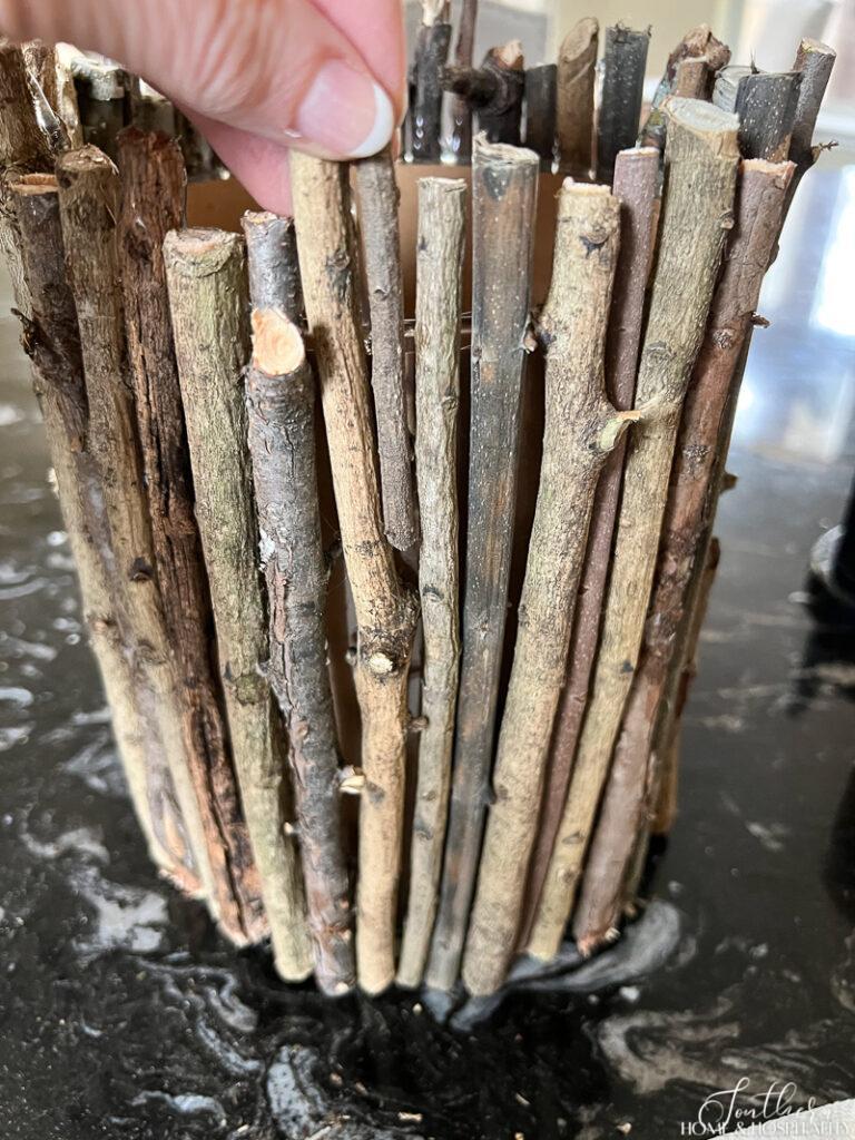 Filling in rustic twig vase with smaller branches