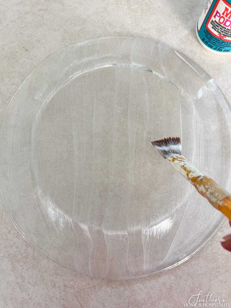 Painting Mod Podge on a clear glass plate