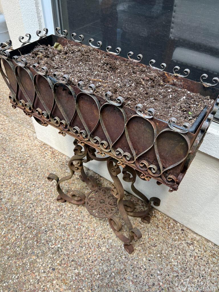 Rusted metal planter before painting
