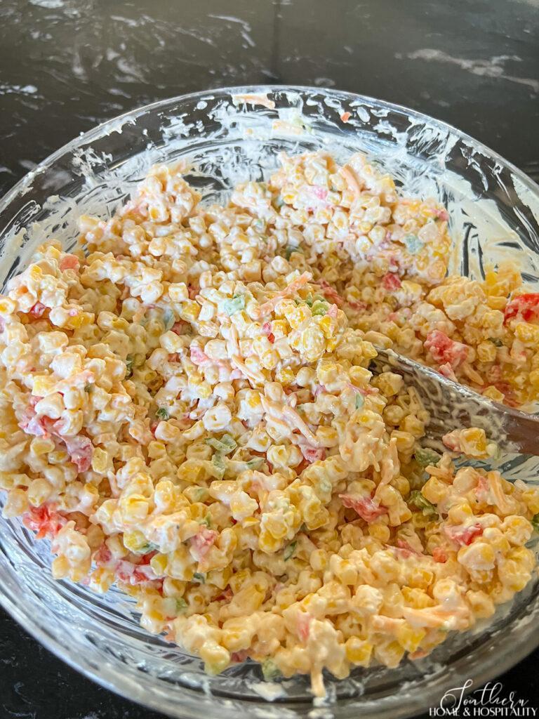 Mixing ingredients for jalapeno corn casserole in a mixing bowl