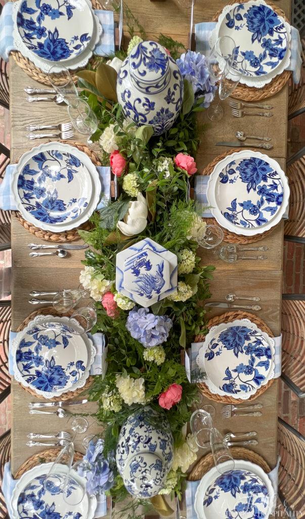Blue and white tablescape with floral runner centerpiece