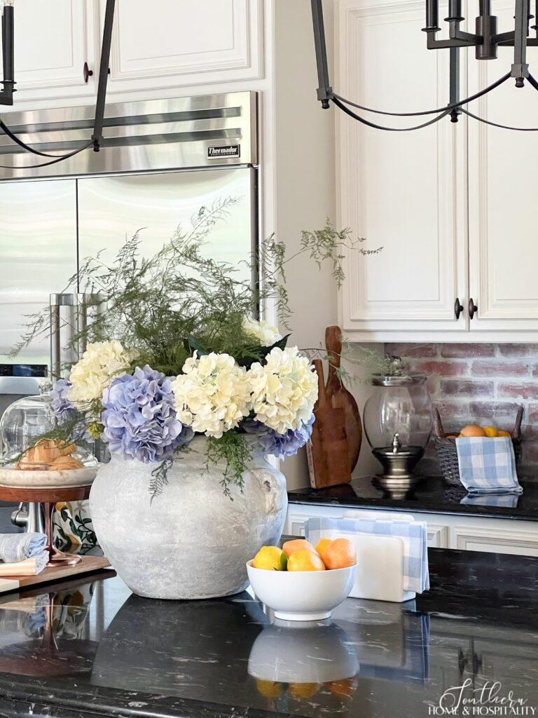 Blue and white hydrangeas summer centerpiece in kitchen with lemons