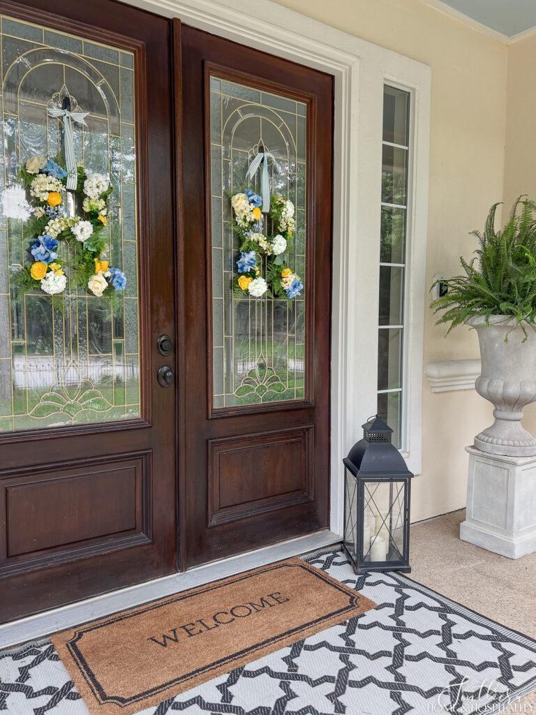 Initial flower wreaths hanging on double front doors