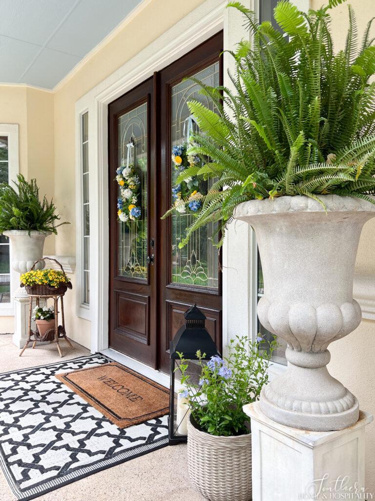 Large ferns flanking double front doors