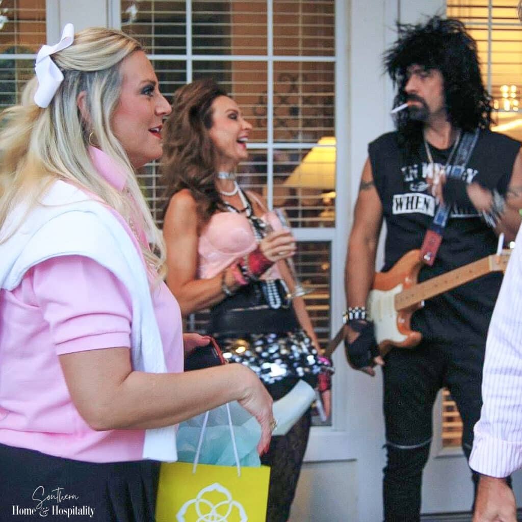 Preppy girl, Madonna, and hair band rocker costumes at 80's party