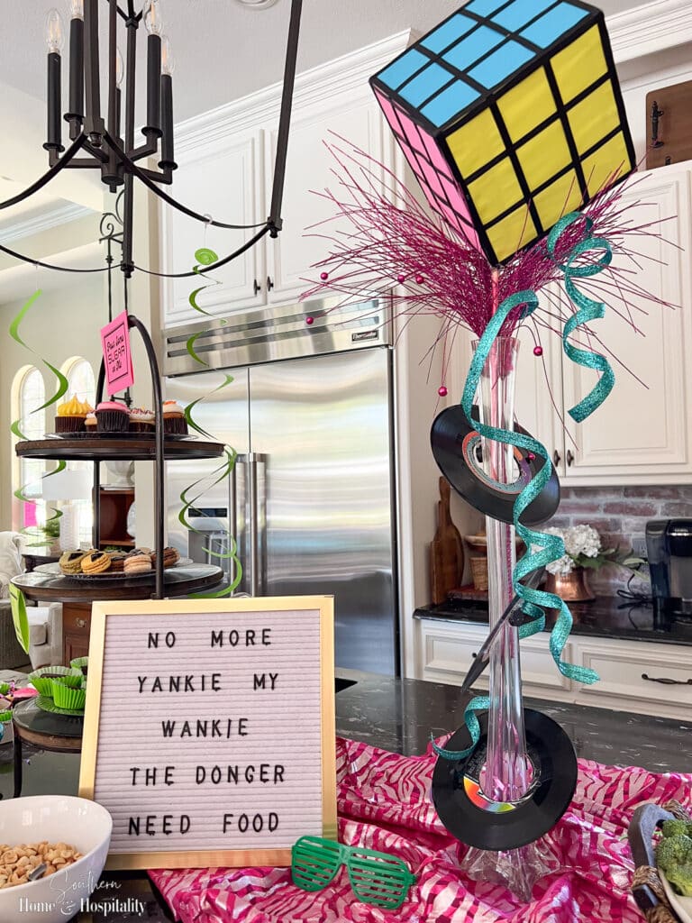 Letter board message for eighties party and rubiks cube vase centerpiece