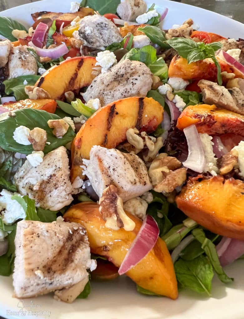 Grilled chicken and peaches with basil, mint, and goat cheese