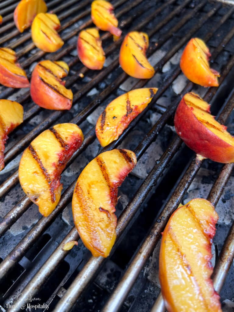 Peach slices on a grill with grill marks