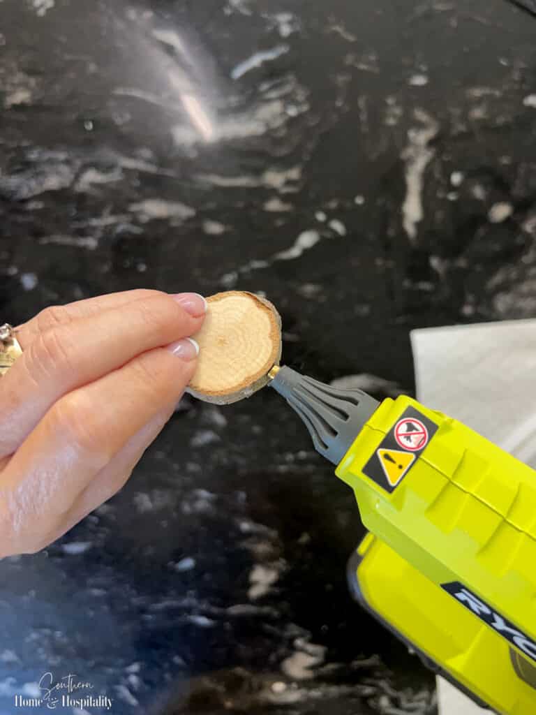 Applying glue to wood slice