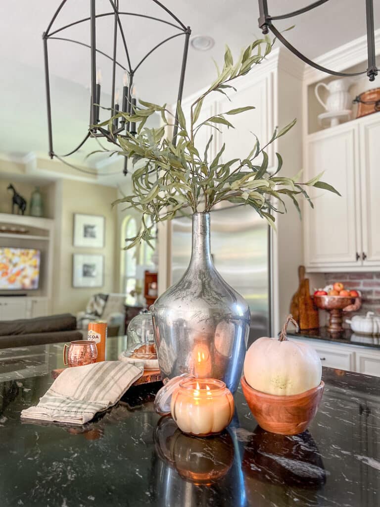 Pumpkin candle in cozy fall kitchen decor
