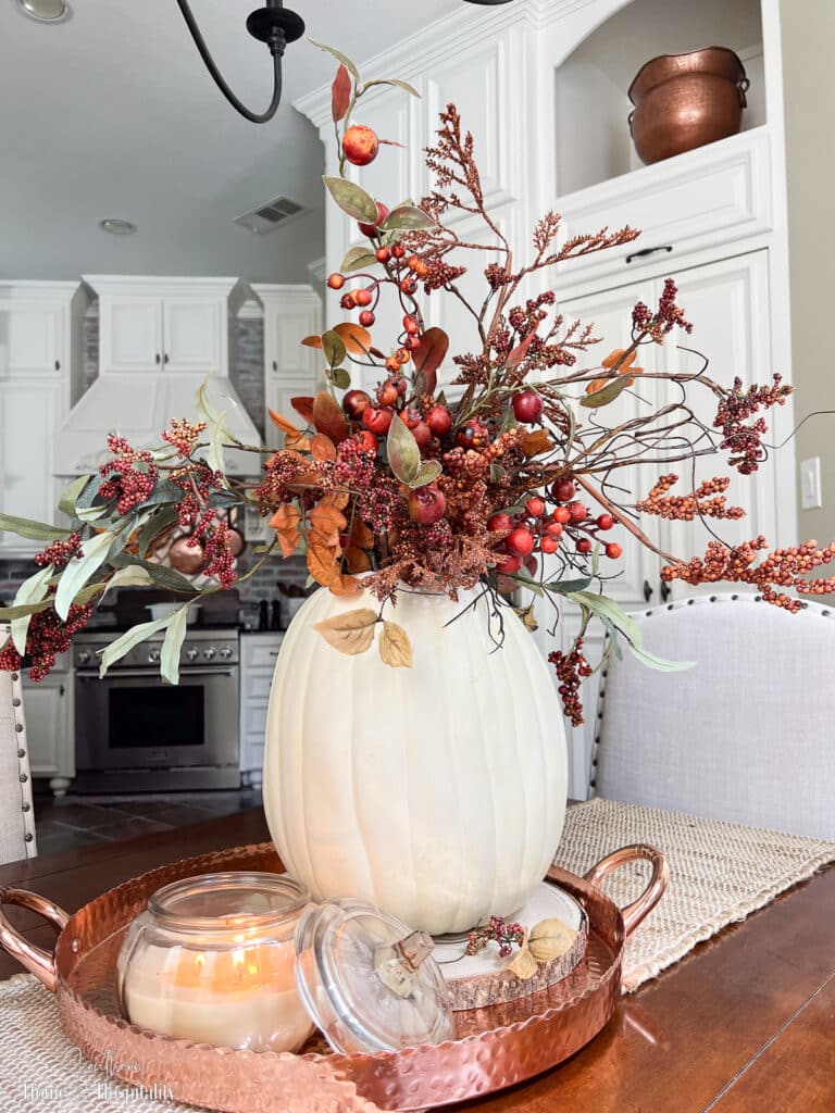 DIY white pumpkin vase with fall berries and leaves