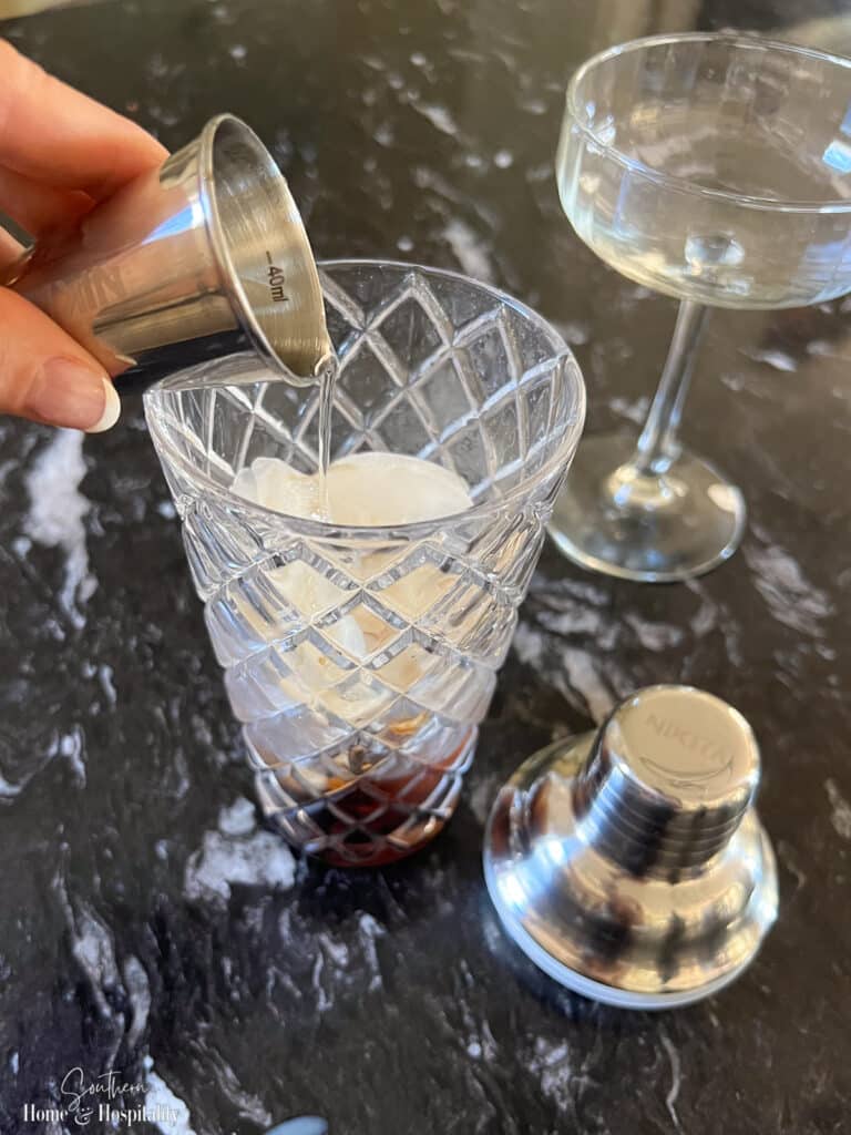 Pouring vodka into espresso martini shaker