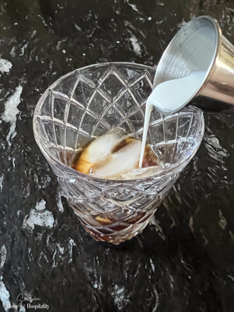 Pouring cream into an espresso martini cocktail