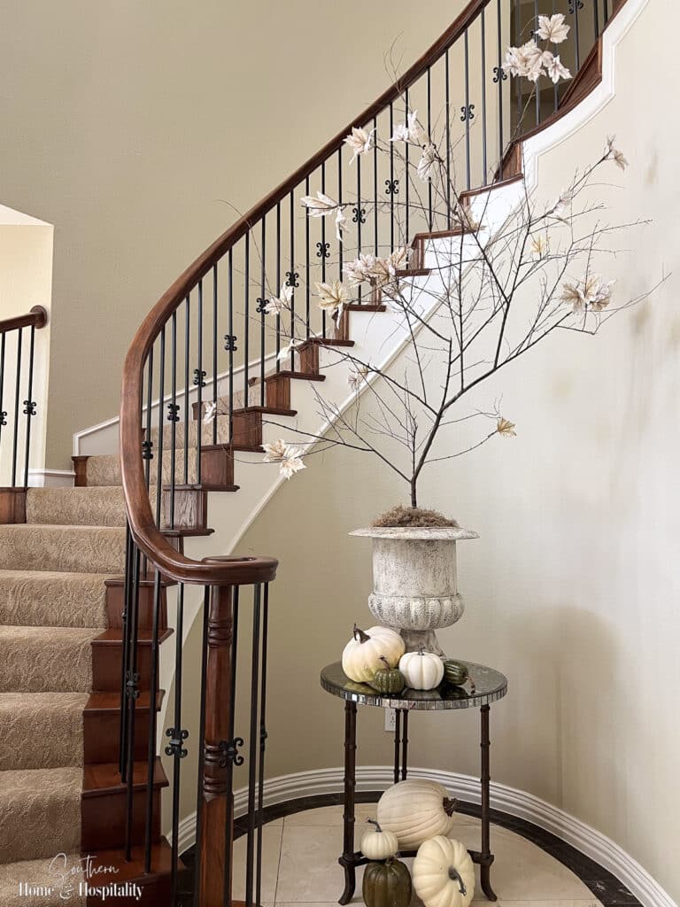 Large fall branch DIY in urn by foyer staircase