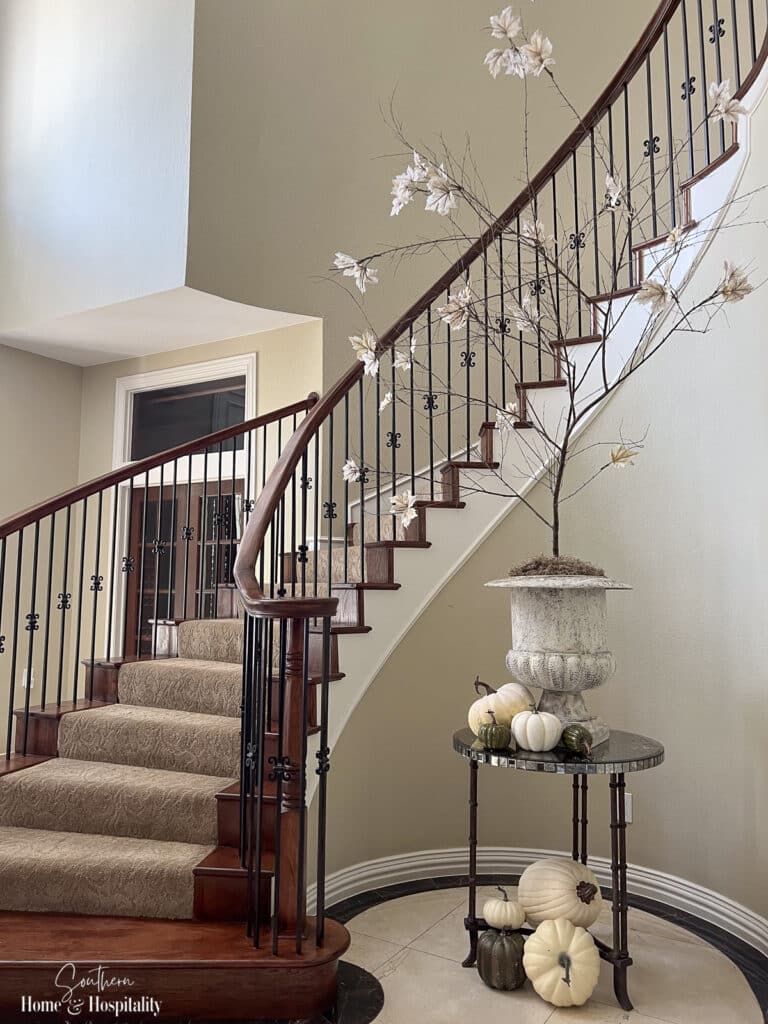Large DIY fall tree in entryway by staircase