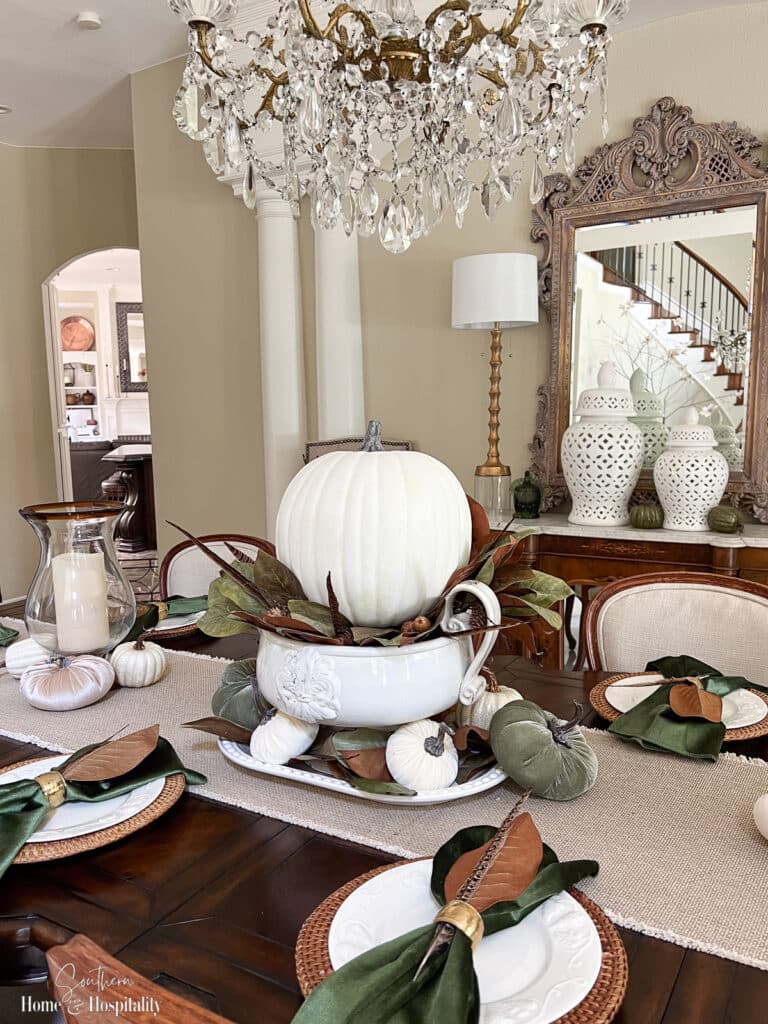 Fall centerpiece with white pumpkin and magnolia leaves