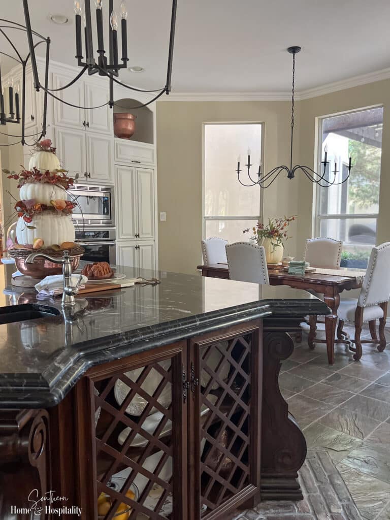 Kitchen island and kitchen table decorated for fall