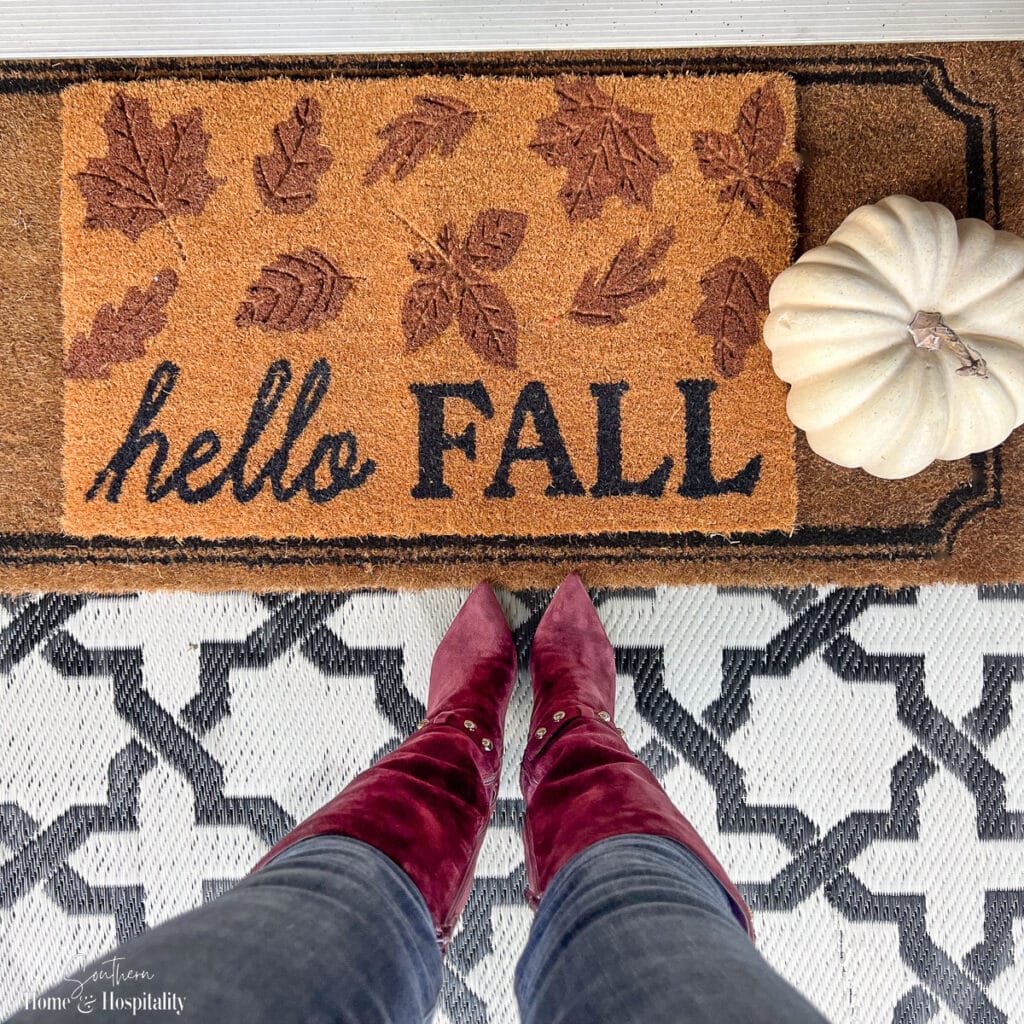 Fall suede boots on fall welcome mat