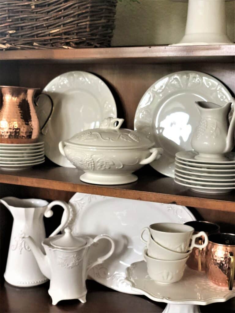 White dishes and copper moscow mule cups and copper pitcher