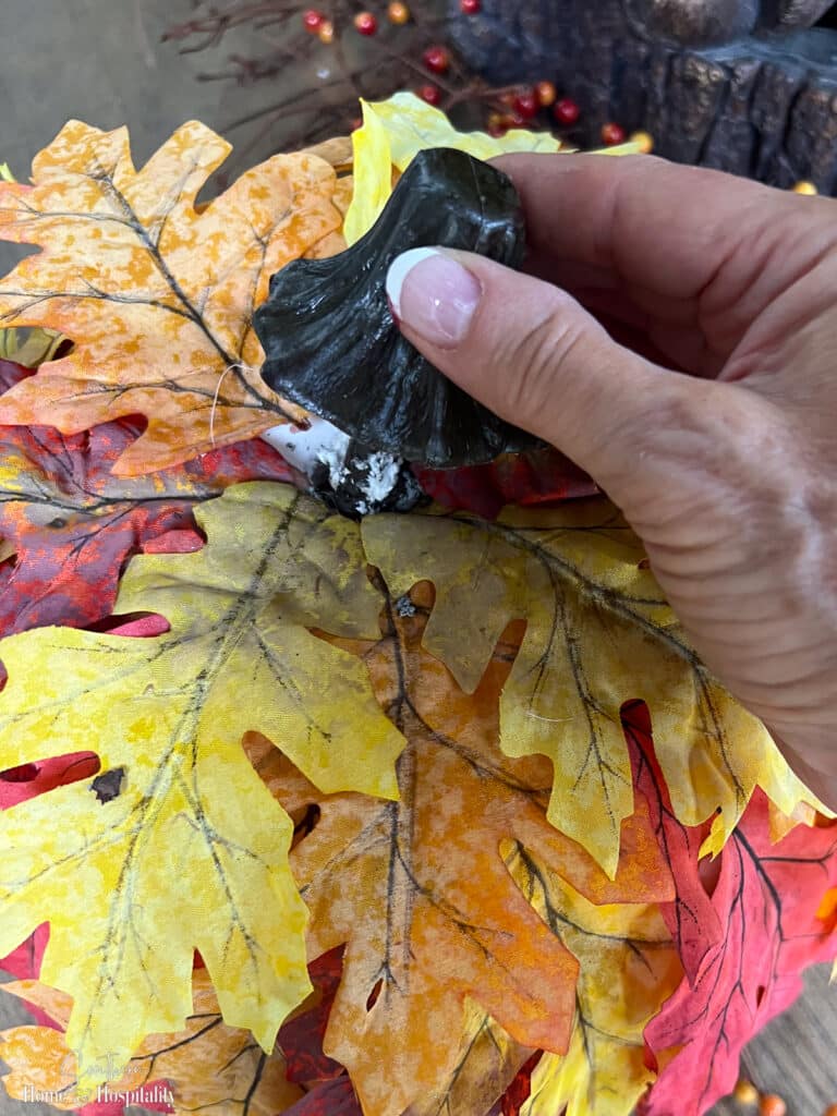 Removing the fake stem from a leaf covered craft pumpkin