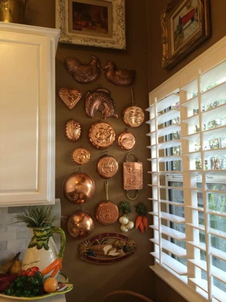 Copper molds hanging on kitchen wall