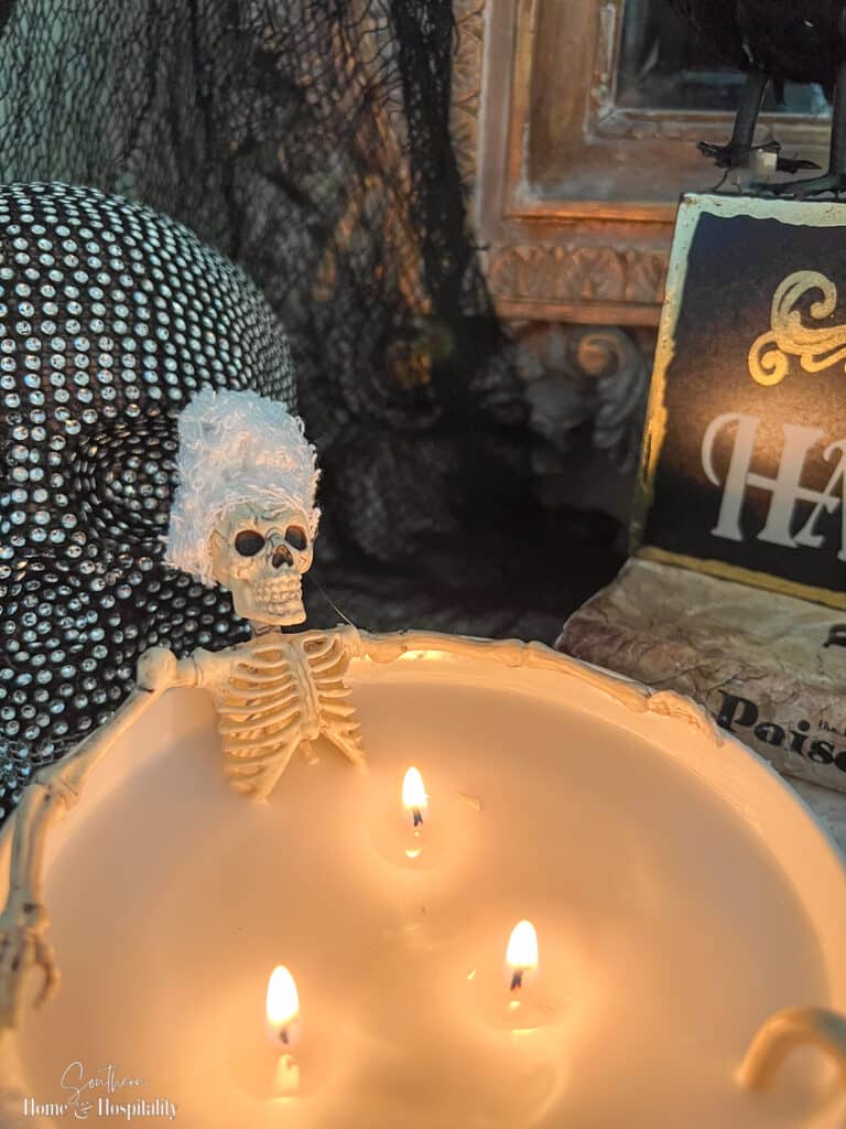 Skeleton soaking in a bathtub candle with towel turban