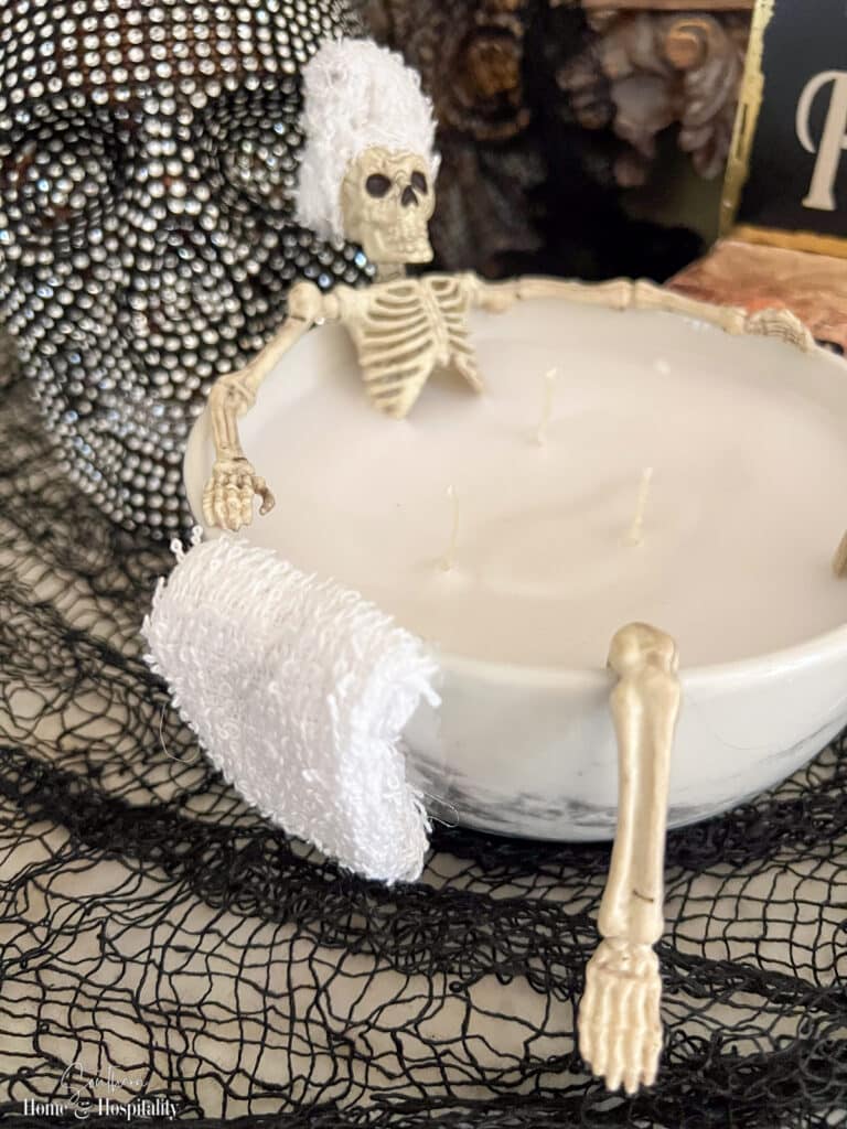 Towel hanging on side of skeleton bathtub candle