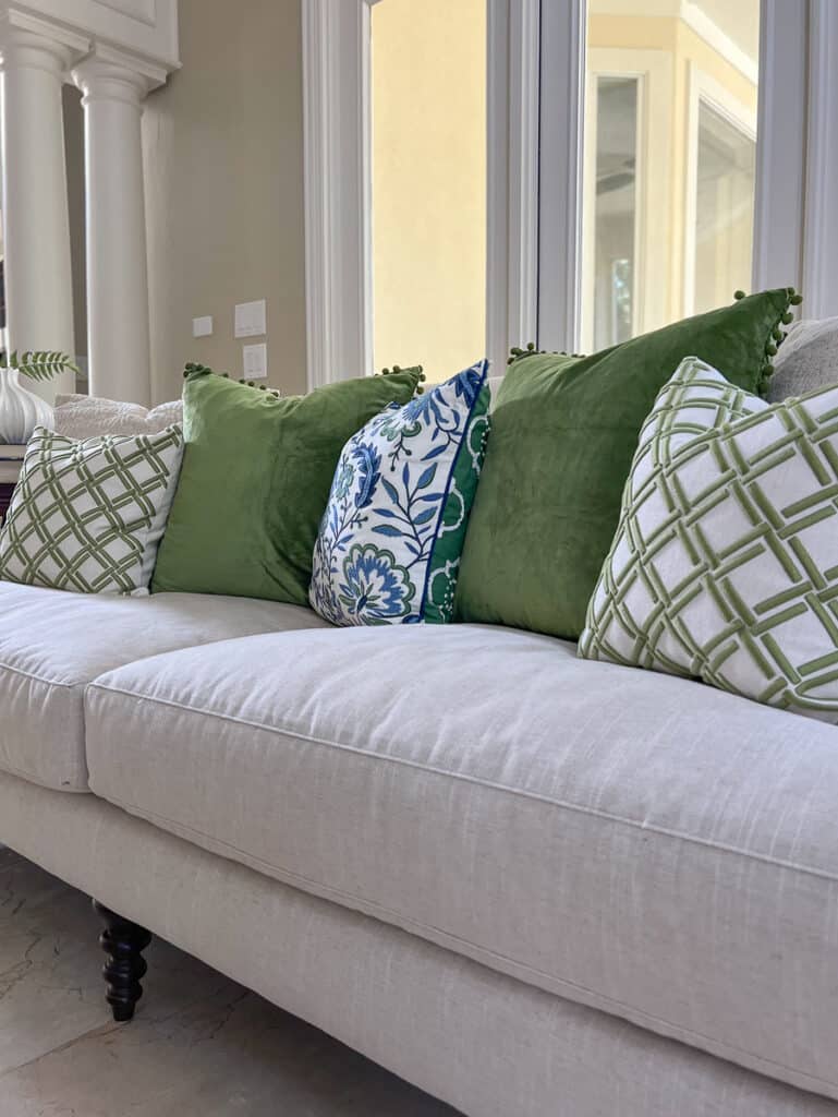 Green velvet throw pillows with pompom fringe
