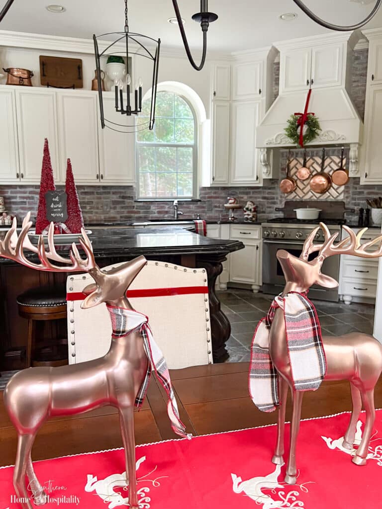 Metal reindeer with plaid ribbon table centerpiece