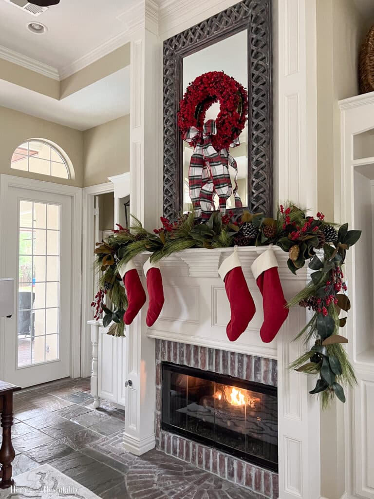 Pine and magnolia Christmas garland on fireplace mantel