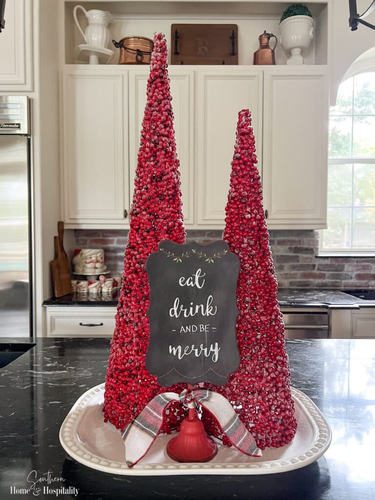 Red berry cones and seasonal sign Christmas vignette