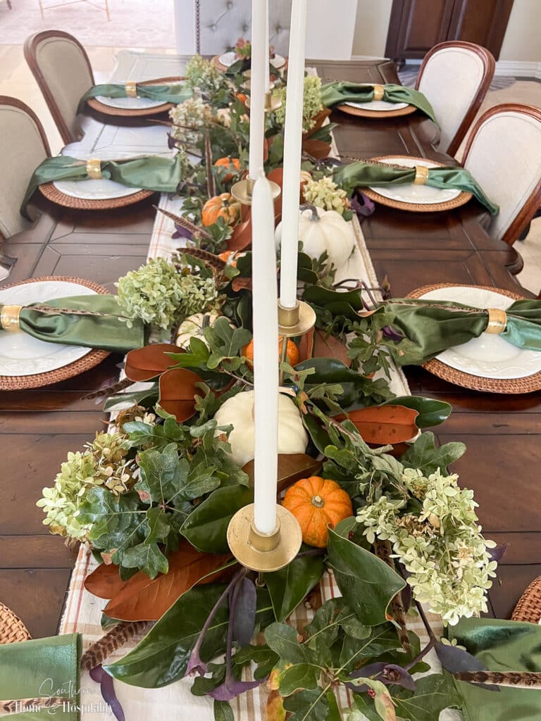 Thanksgiving table decor with foraged oak leaves, magnolia, and hydrangeas