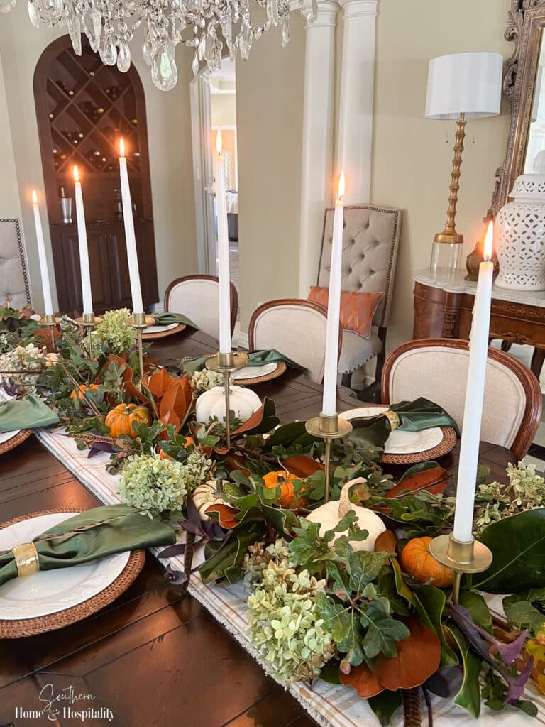 Thanksgiving centerpiece with oak leaves, pumpkins, and hydrangeas