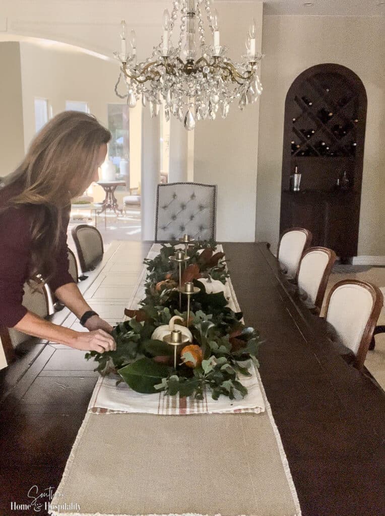 Adding magnolia and greenery to fall table