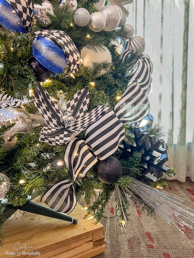 Medium wood snowflakes and harlequin poinsettias on Christmas tree