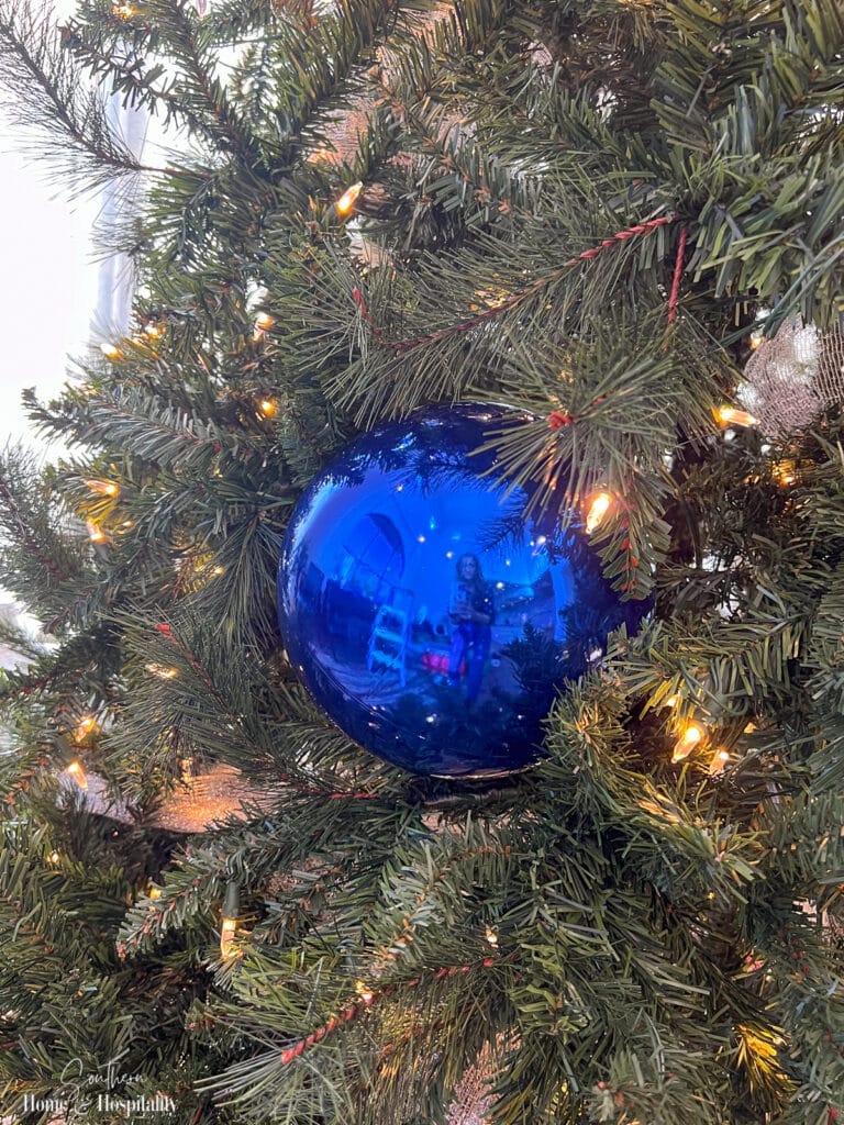 Large ornament ball tucked into tree