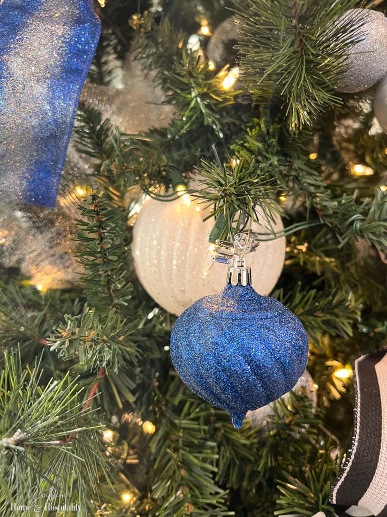 Tree lights shining on glitter ornaments