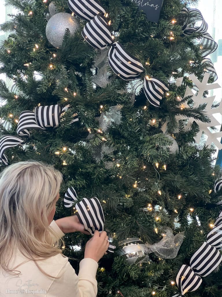 Putting ribbon onto Christmas tree