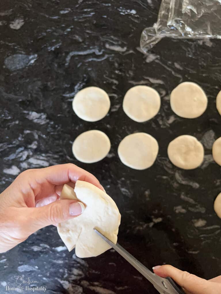 Cutting slits in bread dough for pumpkin shape rolls
