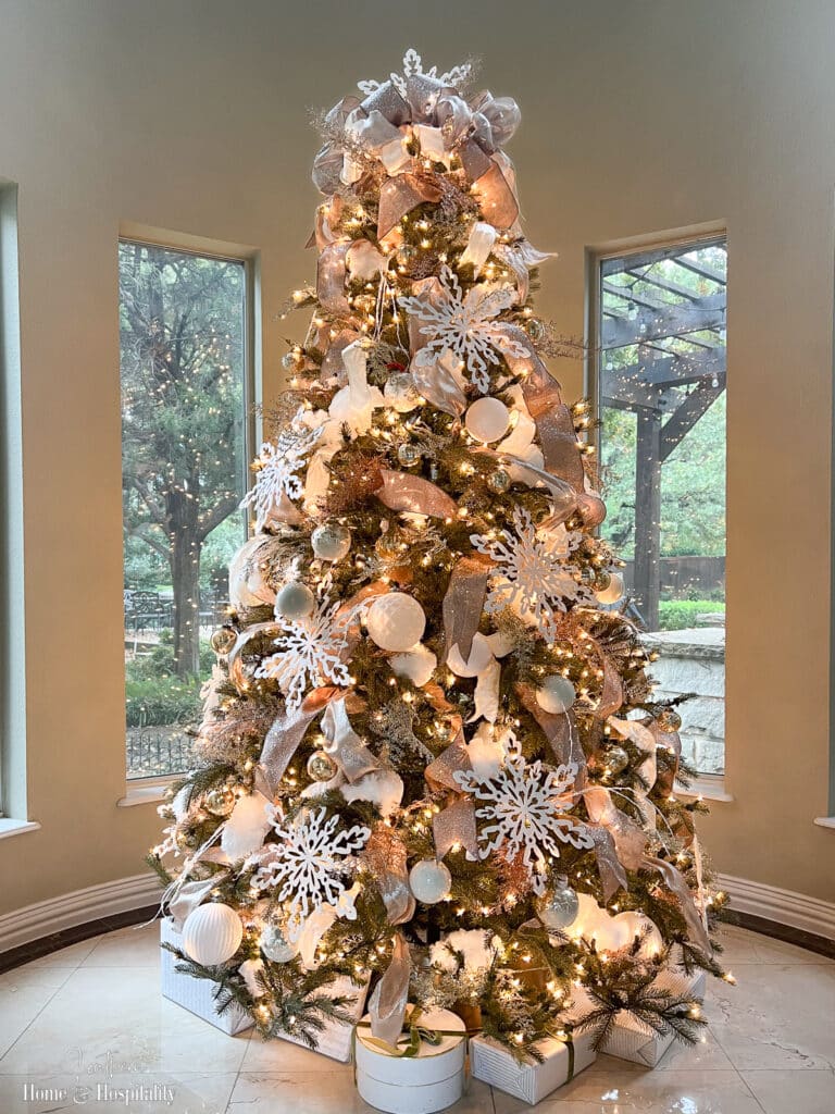 Gold and white Christmas tree with snowflakes and white lights