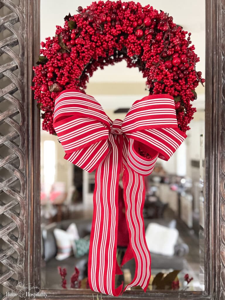 Red berry wreath with red and white stripe simple wreath bow