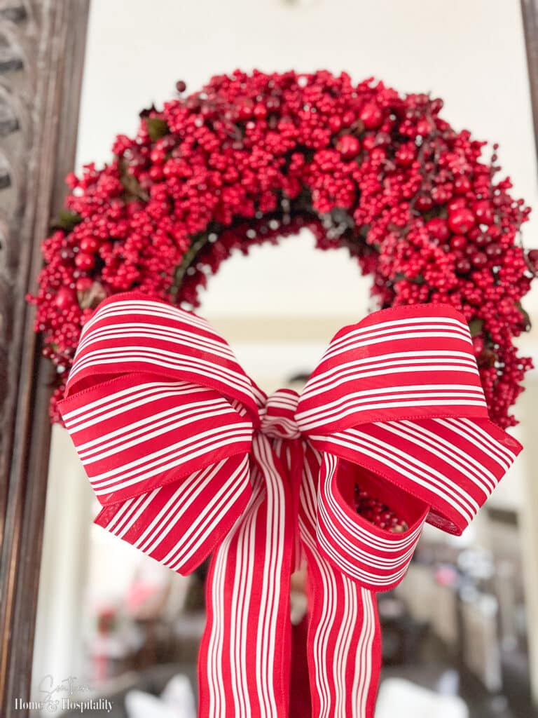 Red and white stripe six loop bow on berry wreath