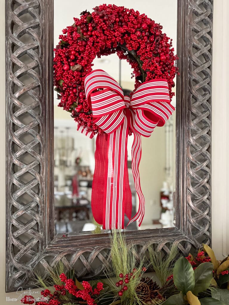 Easy DIY wreath bow tied onto a berry wreath