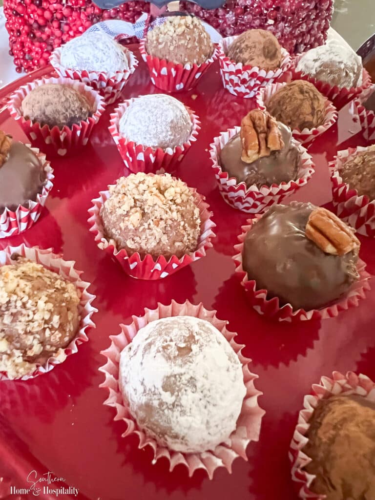 Bourbon balls with powdered sugar, pecans, and chocolate