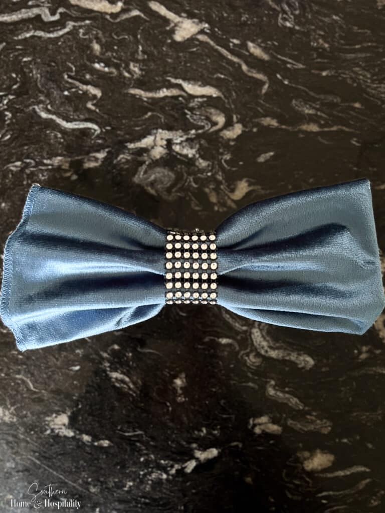Blue velvet bowtie napkin fold